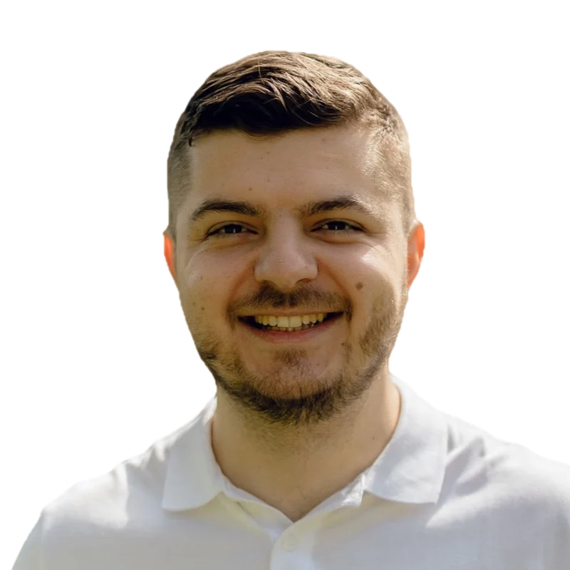 Portrait of Dmytro Zubchenko, smiling, in a white polo shirt